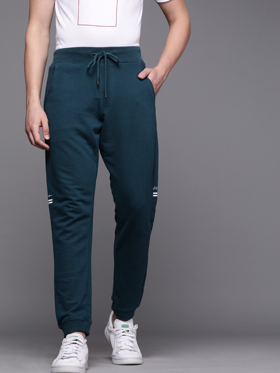 Men WROGN Track Pants & Shorts | Buy Wrogn Men Teal Blue Slim Fit Solid Cropped Joggers With Printed Details - Track Pants For Men 11361924 | Myntra